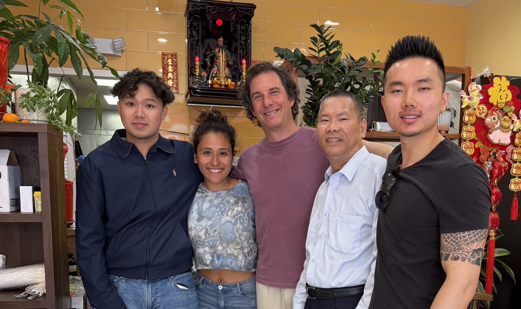 The filmmakers with Chinatown community members inside a neighborhood shop